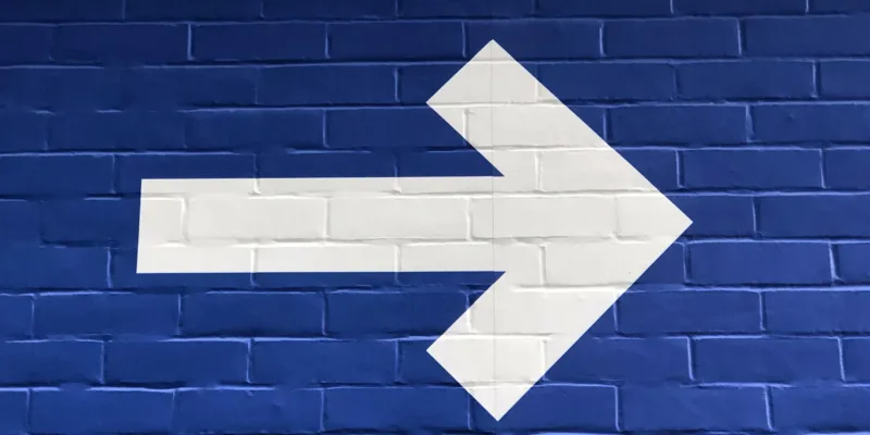 White arrow blue bricks